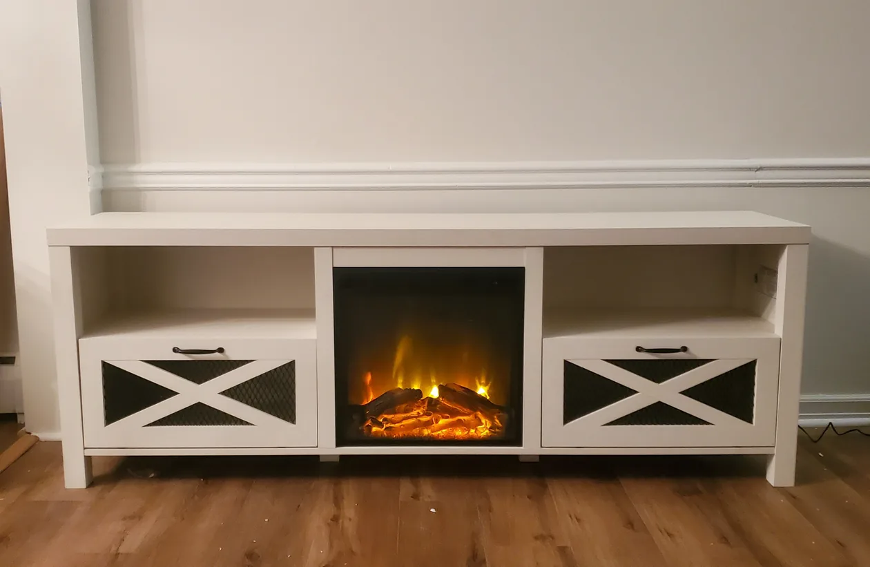 White media console with side storage and an electric fireplace insert.