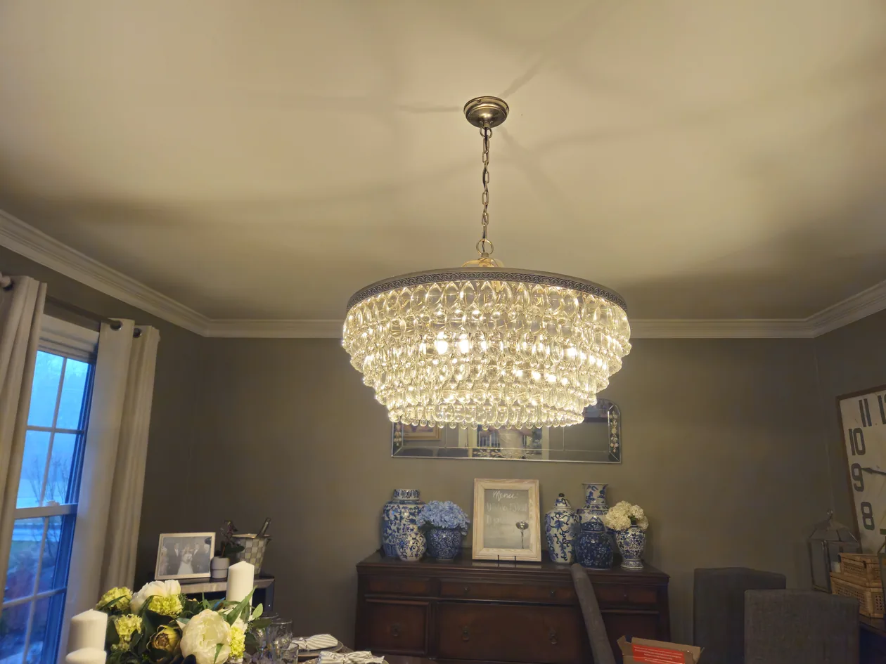 Crystal chandelier hanging in a dining room.