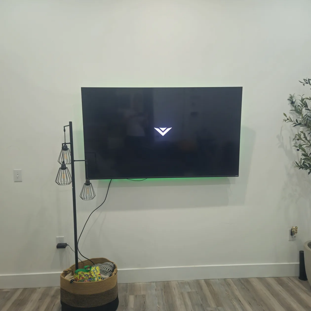 Wall-mounted television above a media console.