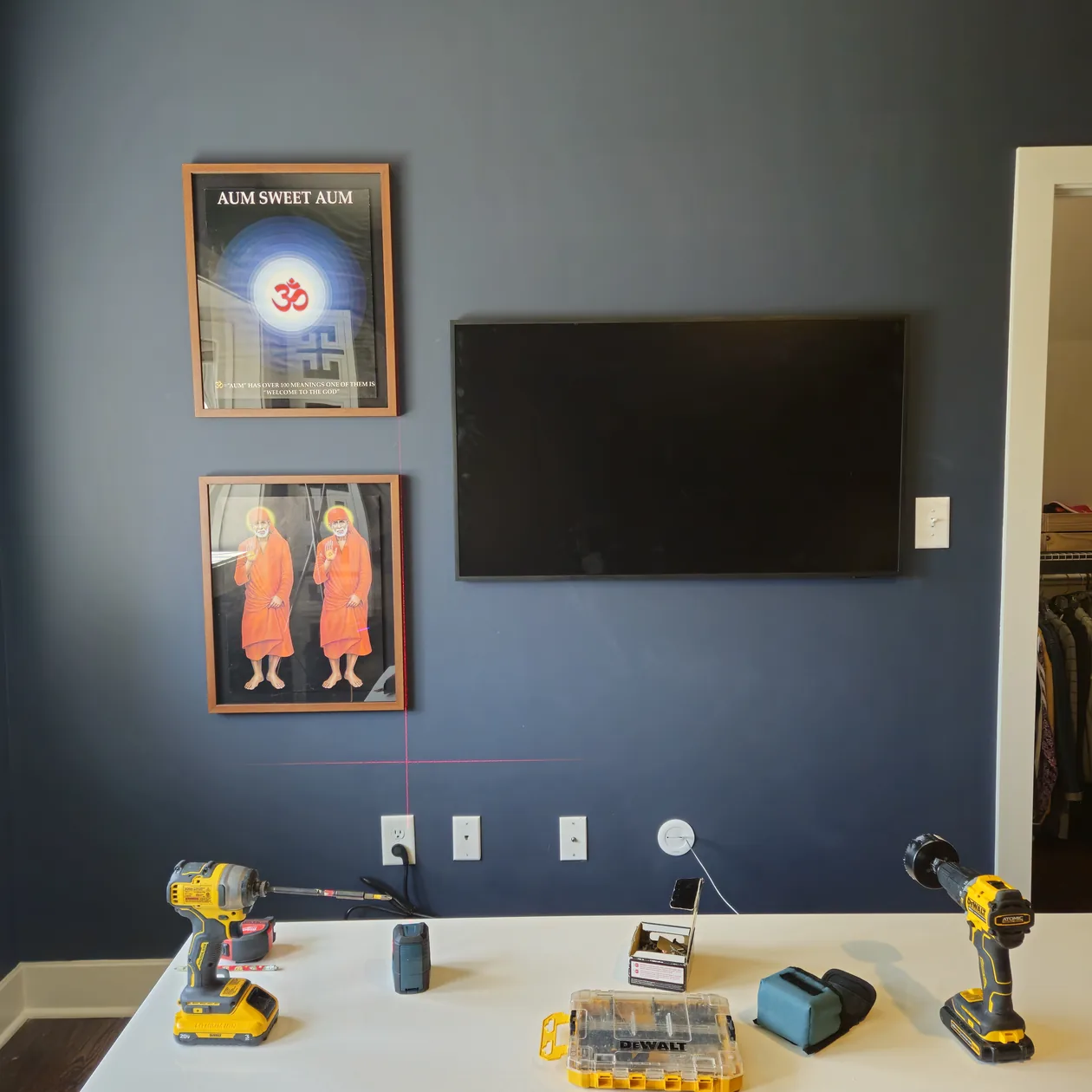 Television and tools on a media wall with wall plates below.